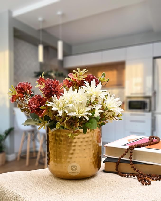 Gold hammered table vase with artificial flowers in a modern home